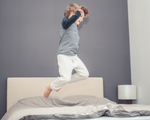 kid jumping on the bed