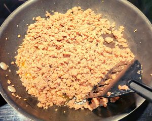 Breakfast sausage cooking in a pan