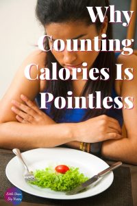 Woman staring at a small plate of salad. Text says: Why Counting Calories is Pointless